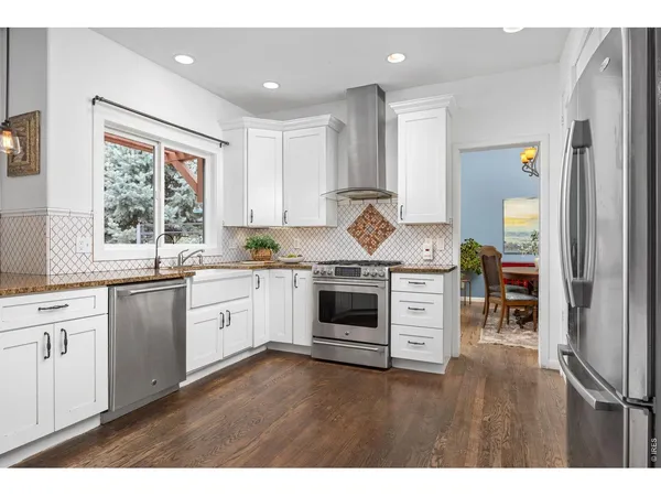 a kitchen with a stove a sink and a refrigerator