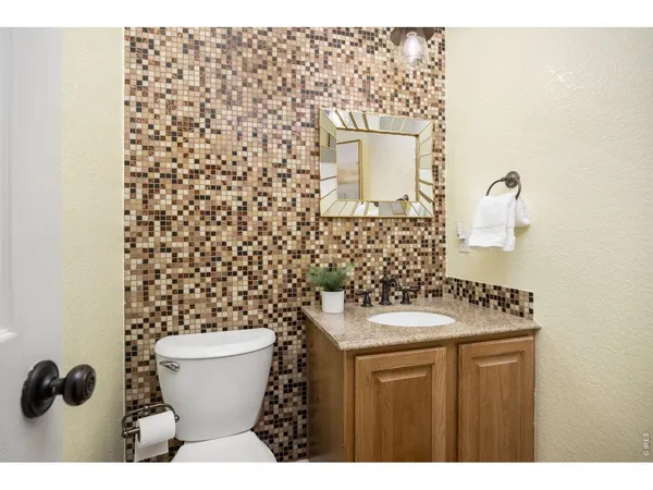 a bathroom with a sink toilet and mirror