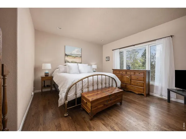 a bed room with a bed window and a television