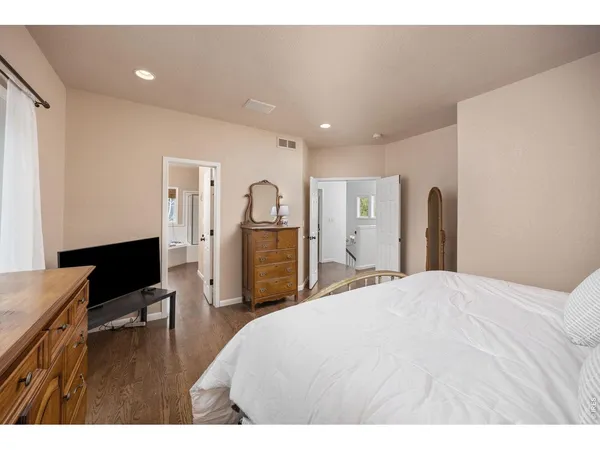 a spacious bedroom with a bed and a table in it
