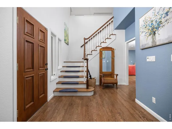 a view of entryway with wooden floor and stairs
