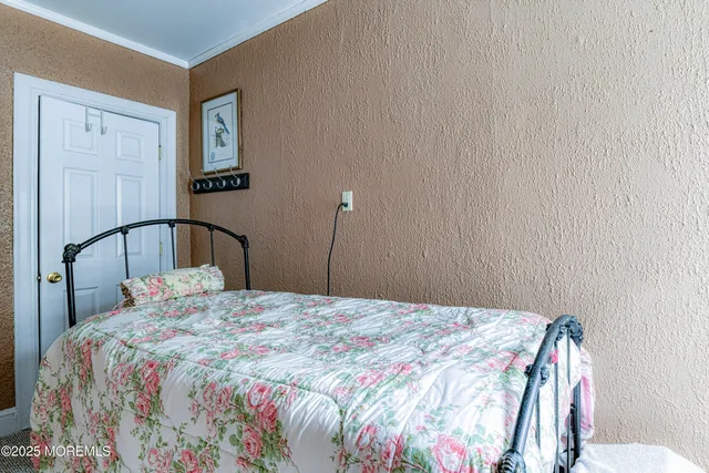 a bedroom with a bed and a lamp