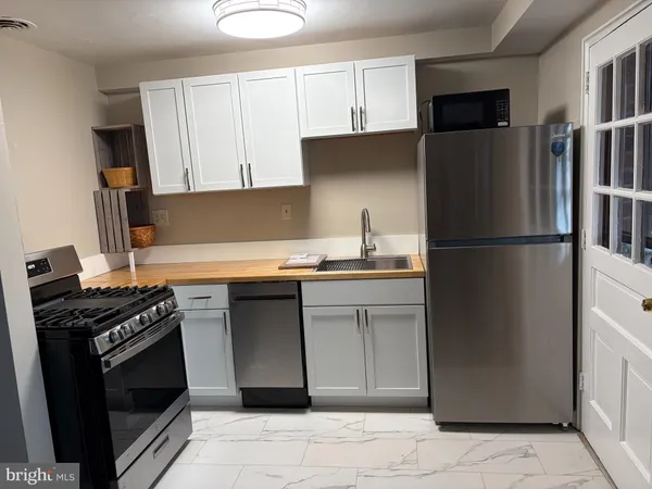a kitchen with a refrigerator stove and cabinets