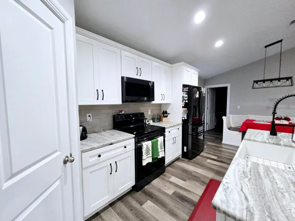 a kitchen with a sink appliances and cabinets