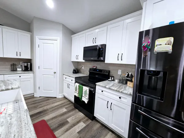 a kitchen with a sink appliances and cabinets