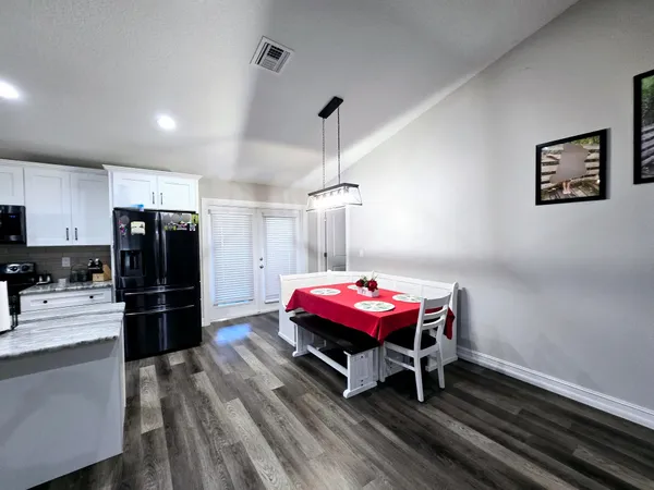 a kitchen with a refrigerator and a wooden cabinets