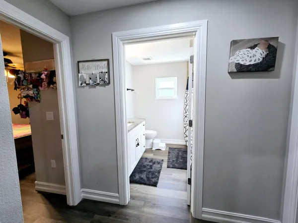 a view of a hallway view with wooden floor and closet