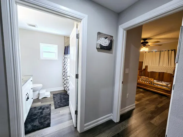 a view of a room that has a bed and a mirror
