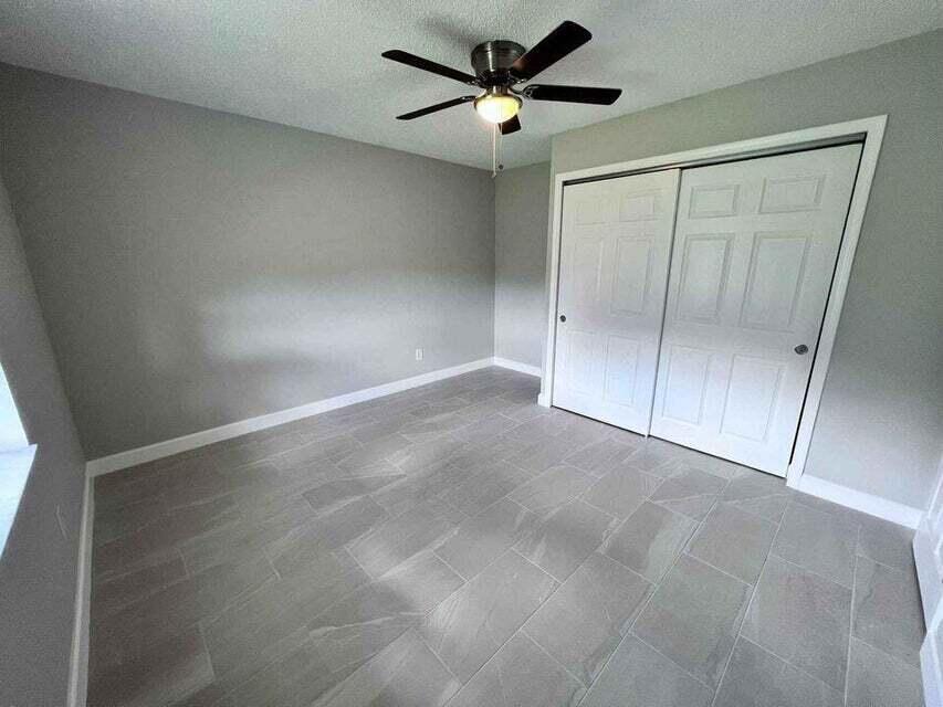 2410 South Brocksmith Road Fort Pierce, FL 34945 - Photo 14 of 65 a view of an empty room with a fan