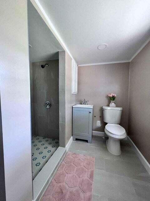2410 South Brocksmith Road Fort Pierce, FL 34945 - Photo 19 of 65 a bathroom with a sink toilet and shower