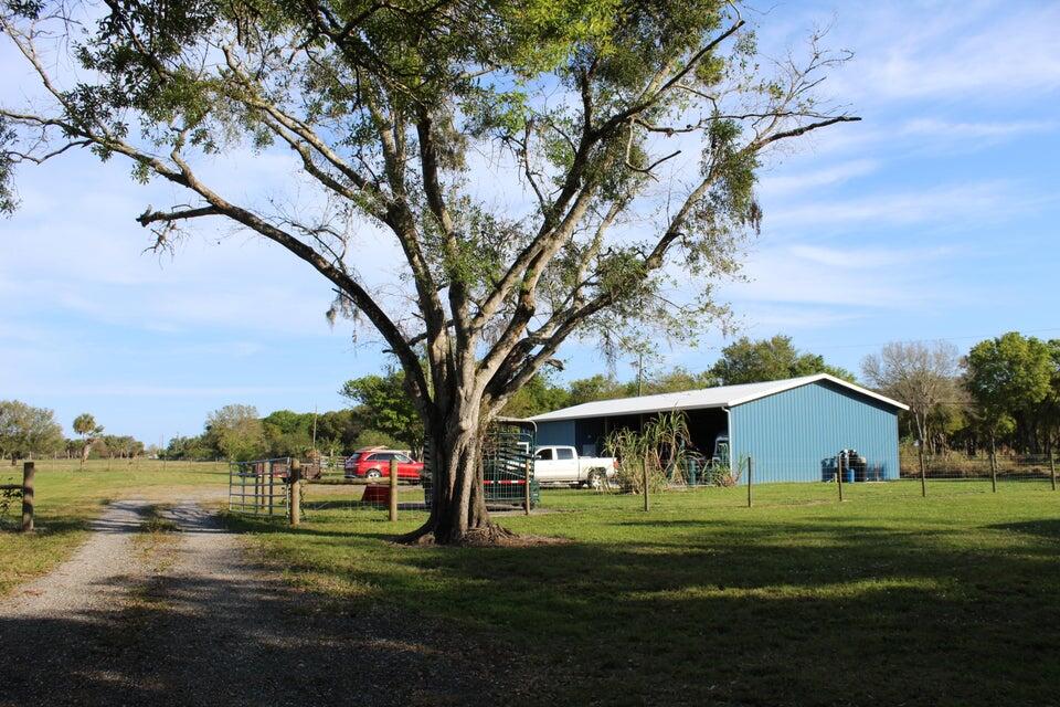 2410 South Brocksmith Road Fort Pierce, FL 34945 - Photo 21 of 65 a view of a house with a yard
