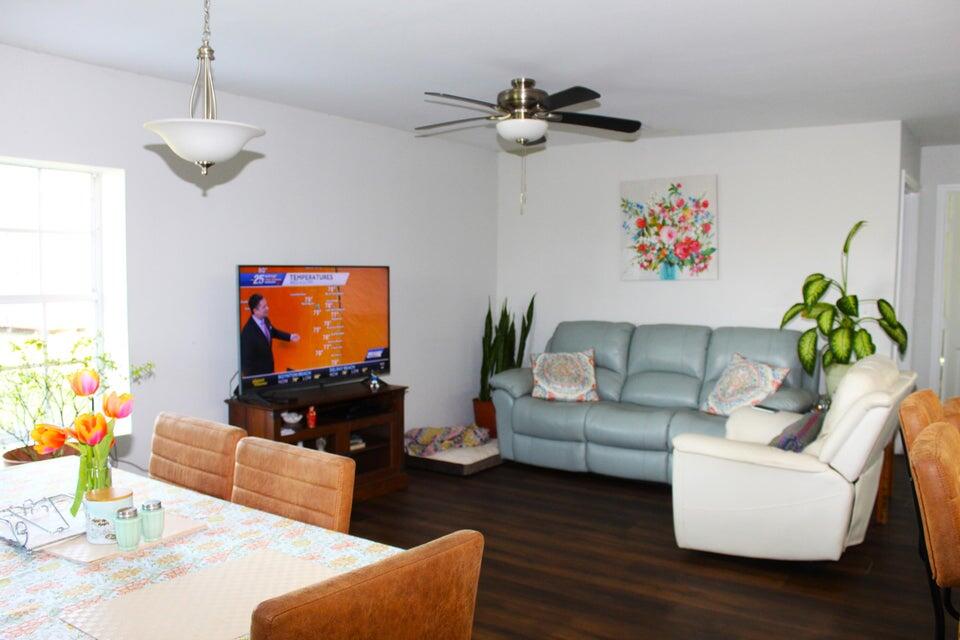 2410 South Brocksmith Road Fort Pierce, FL 34945 - Photo 56 of 65 a living room with furniture and a flat screen tv