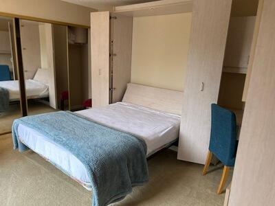 1420 Ocean Way, Unit 14D Jupiter, FL 33477 - Photo 19 of 34 a bedroom with a bed and a mirror