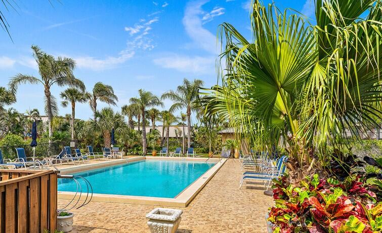 1420 Ocean Way, Unit 14D Jupiter, FL 33477 - Photo 32 of 34 a view of swimming pool with outdoor seating and plants