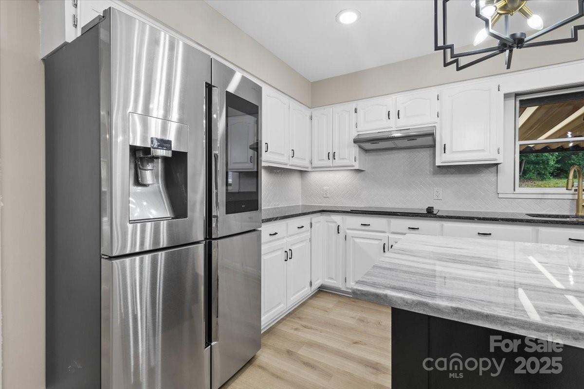 5916 Cashion Road Huntersville, NC 28078 - Photo 12 of 45 a kitchen with stainless steel appliances granite countertop a refrigerator sink and cabinets