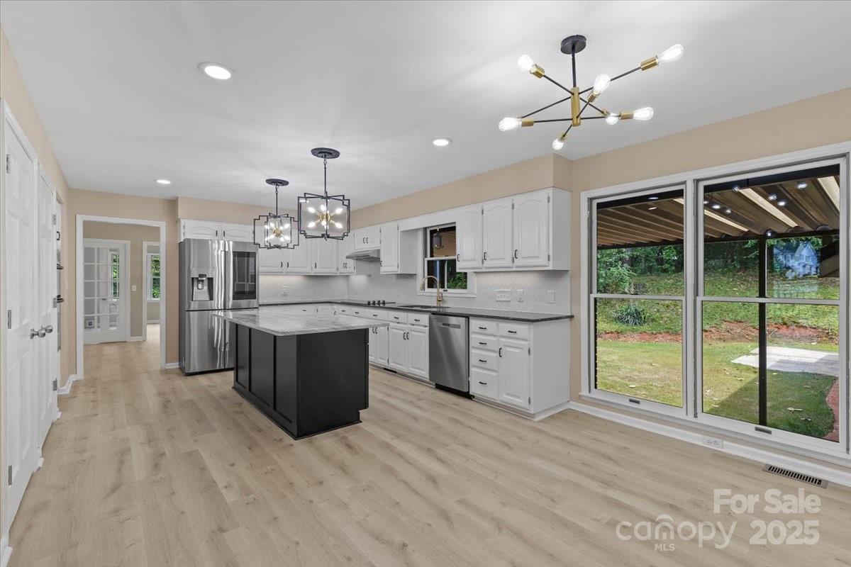 5916 Cashion Road Huntersville, NC 28078 - Photo 13 of 45 a large kitchen with a large counter top a sink stainless steel appliances and cabinets