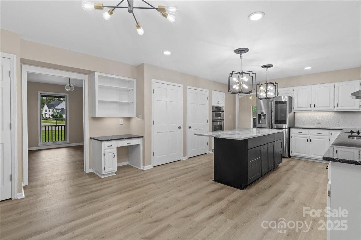 5916 Cashion Road Huntersville, NC 28078 - Photo 14 of 45 a large kitchen with cabinets wooden floor and stainless steel appliances