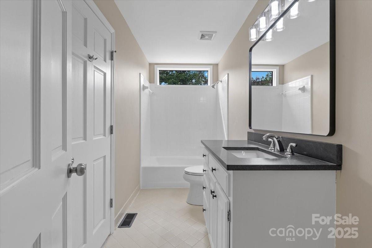 5916 Cashion Road Huntersville, NC 28078 - Photo 20 of 45 a bathroom with a granite countertop sink and a mirror
