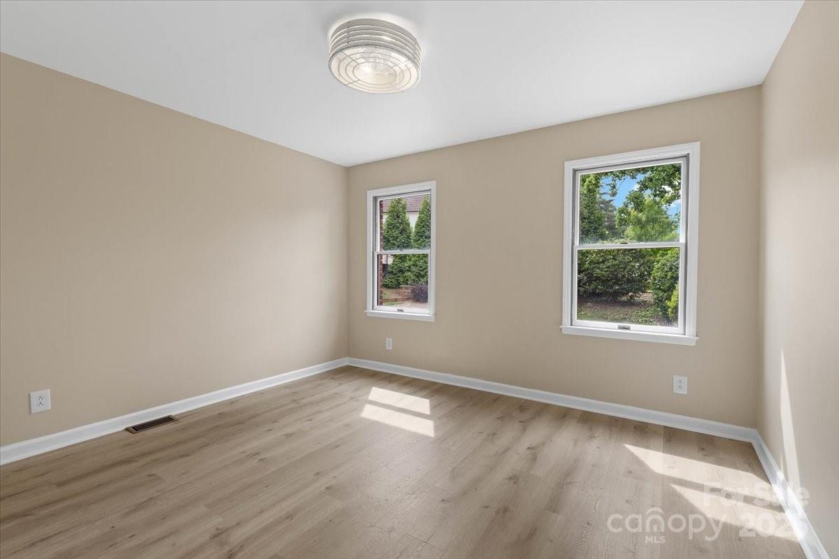 5916 Cashion Road Huntersville, NC 28078 - Photo 21 of 45 an empty room with wooden floor and windows