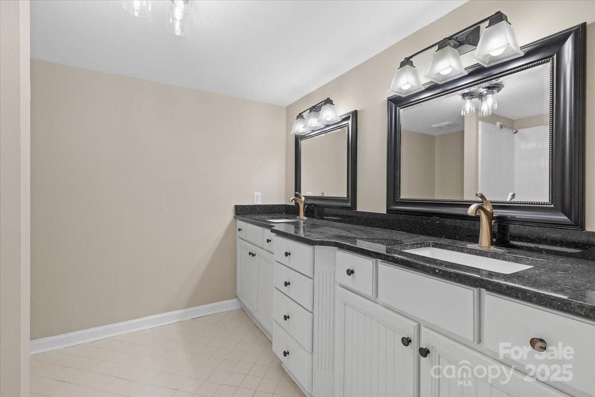 5916 Cashion Road Huntersville, NC 28078 - Photo 27 of 45 a bathroom with a granite countertop sink and a mirror