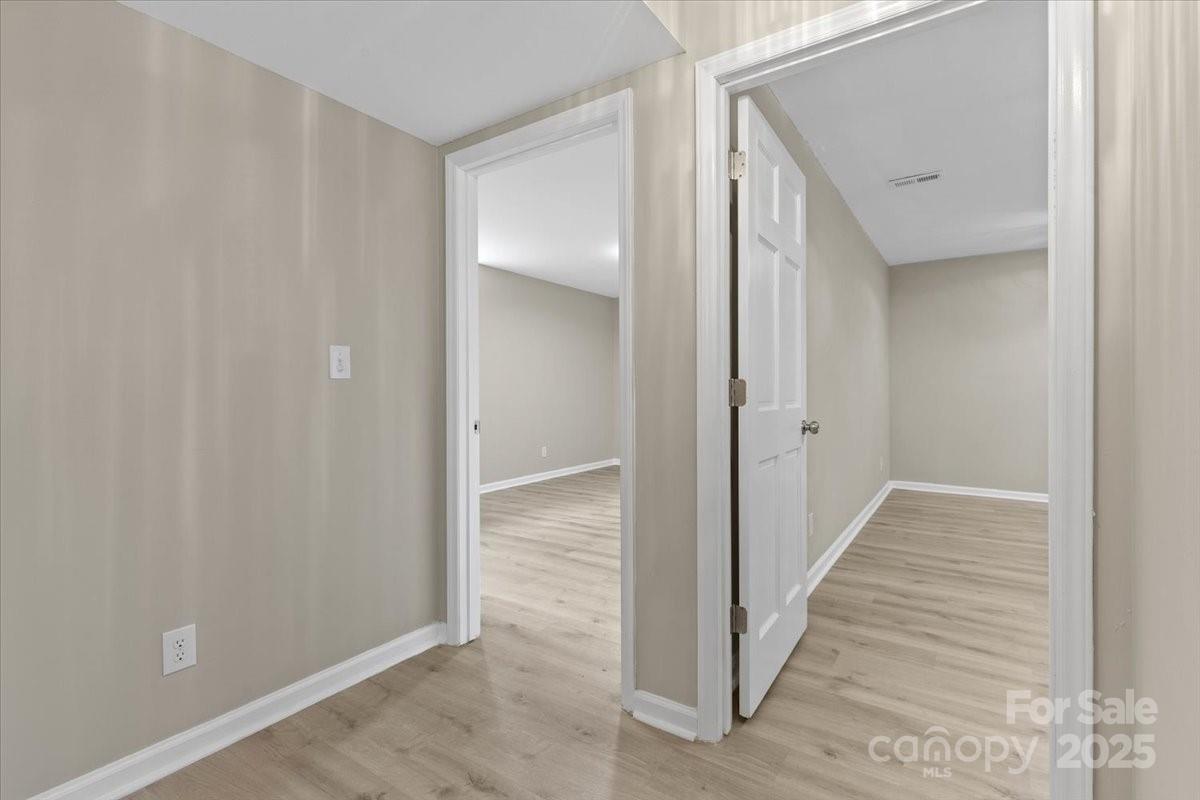 5916 Cashion Road Huntersville, NC 28078 - Photo 30 of 45 a view of a hallway with wooden floor