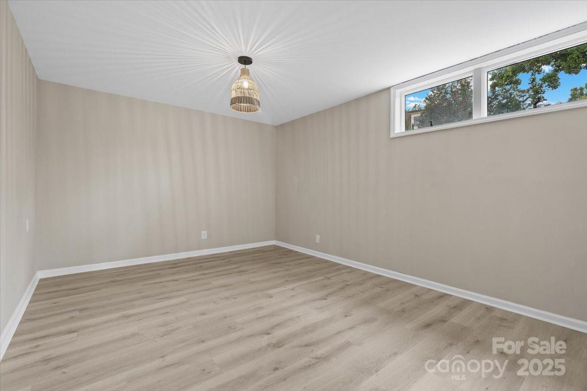 5916 Cashion Road Huntersville, NC 28078 - Photo 33 of 45 a view of an empty room with wooden floor and a window