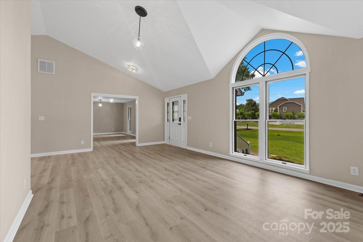 5916 Cashion Road Huntersville, NC 28078 - Photo 4 of 45 a view of an empty room with a window and wooden floor