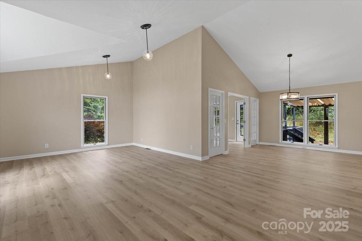 5916 Cashion Road Huntersville, NC 28078 - Photo 5 of 45 a view of an empty room with wooden floor kitchen view and a window