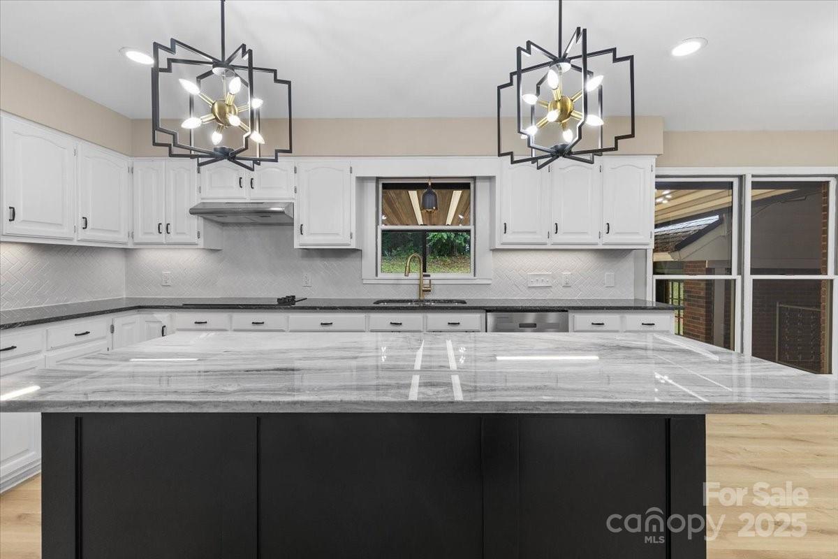 5916 Cashion Road Huntersville, NC 28078 - Photo 9 of 45 a kitchen with kitchen island granite countertop a sink cabinets and window