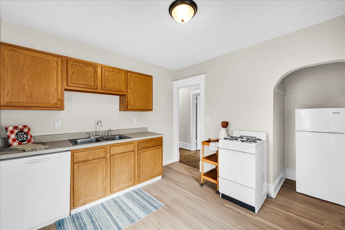 1018 North Prairie Street Bloomington, IL 61701 - Photo 17 of 49 a kitchen with a sink stove and wooden cabinets