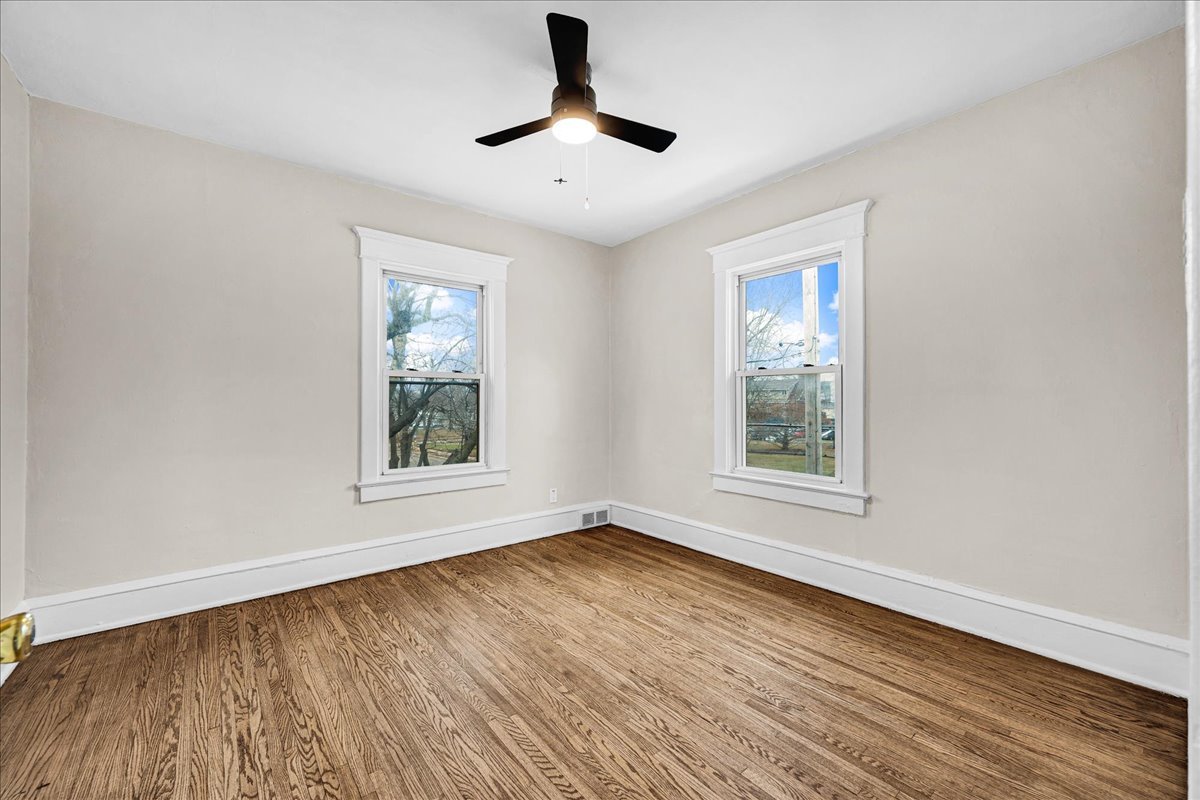 1018 North Prairie Street Bloomington, IL 61701 - Photo 19 of 49 a view of an empty room with wooden floor and a window