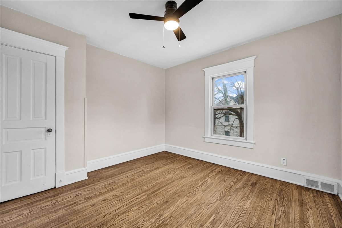 1018 North Prairie Street Bloomington, IL 61701 - Photo 21 of 49 wooden floor in an empty room with a window