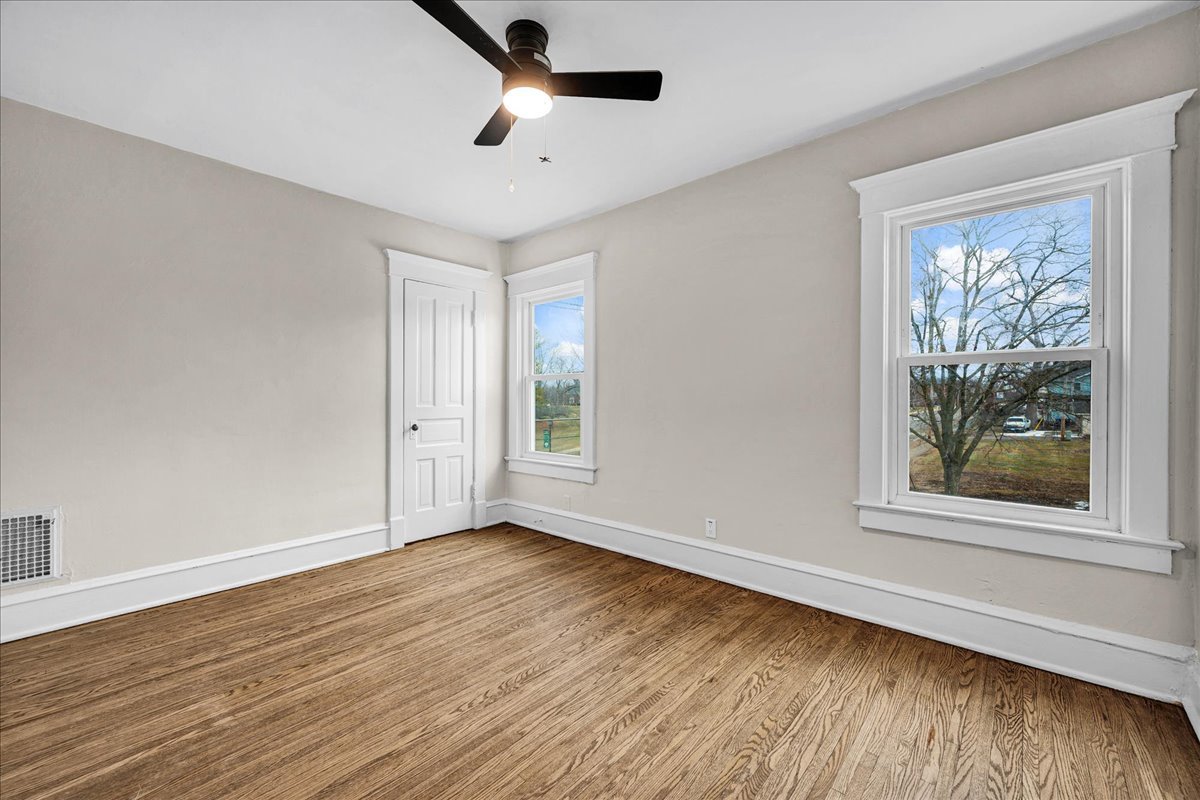 1018 North Prairie Street Bloomington, IL 61701 - Photo 22 of 49 a view of an empty room with wooden floor and a window