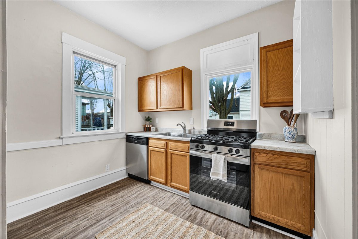 1018 North Prairie Street Bloomington, IL 61701 - Photo 3 of 49 a kitchen with stainless steel appliances granite countertop a stove a sink and a microwave
