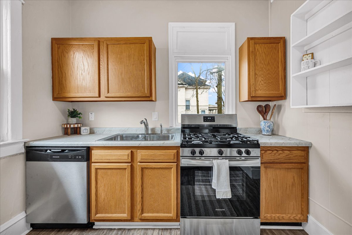 1018 North Prairie Street Bloomington, IL 61701 - Photo 4 of 49 a kitchen with granite countertop a stove top oven sink and cabinets