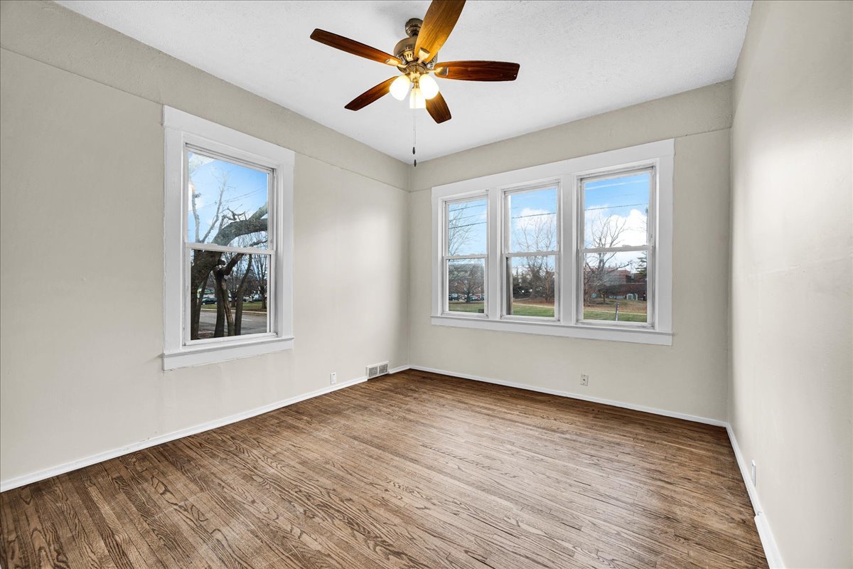 1018 North Prairie Street Bloomington, IL 61701 - Photo 8 of 49 a view of an empty room with window and wooden floor