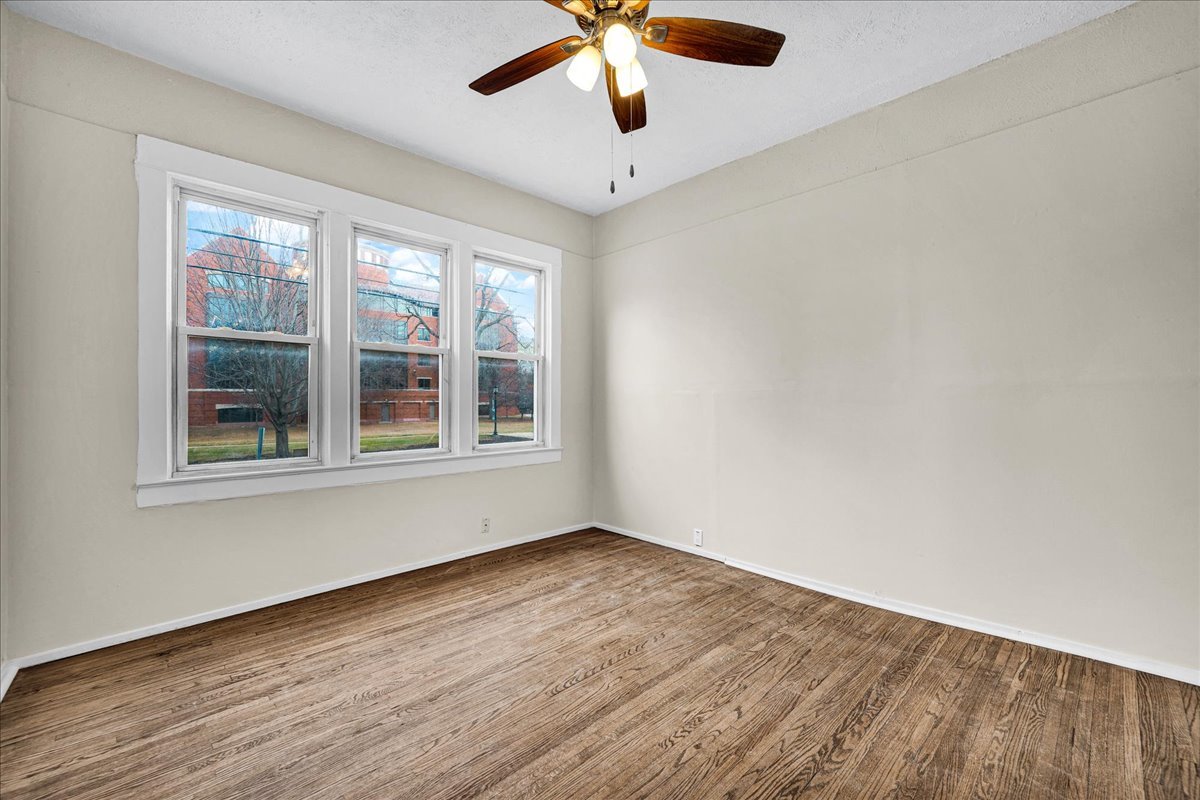 1018 North Prairie Street Bloomington, IL 61701 - Photo 9 of 49 a view of an empty room with wooden floor and a window