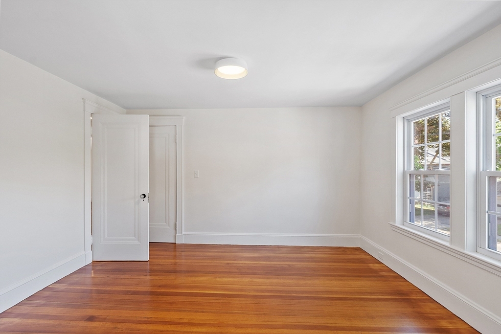 15 Marion Road Watertown, MA 02472 - Photo 28 of 41 a view of an empty room with wooden floor and a window