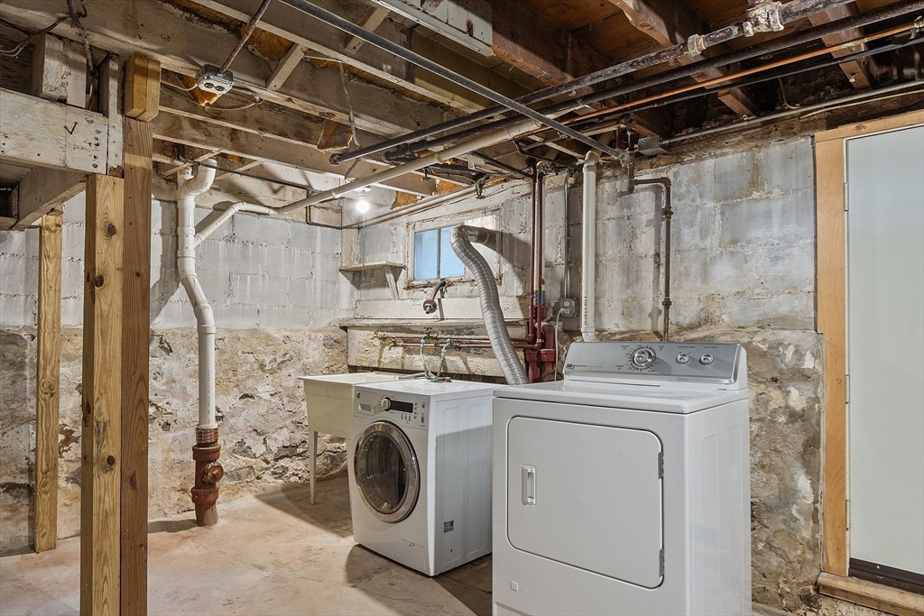 15 Marion Road Watertown, MA 02472 - Photo 31 of 41 a view of a storage & utility room with dryer and washer