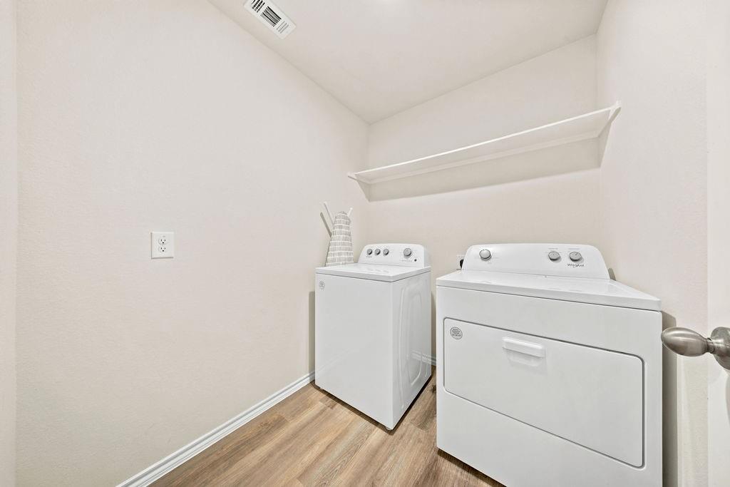 822 Ramble Road Lavon, TX 75166 - Photo 7 of 35 Dedicated laundry area featuring wood-finish flooring, a white floating shelf, and white baseboards