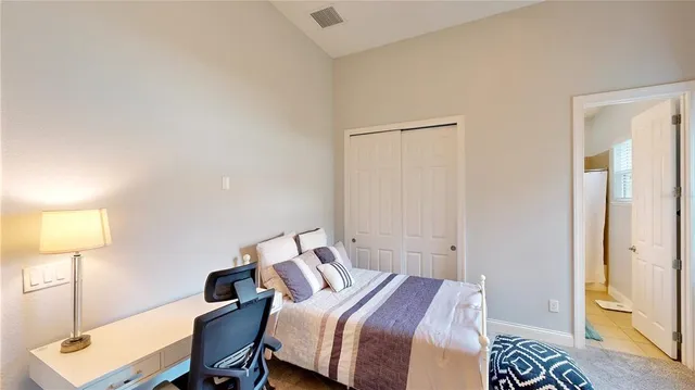 a view of swimming pool with lawn chairs and plants