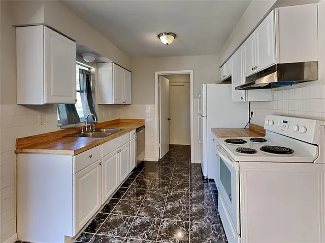 a kitchen with stainless steel appliances granite countertop a stove and a sink
