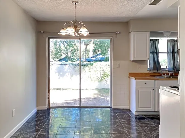 a view of a kitchen with a stove cabinets and a floor to ceiling window