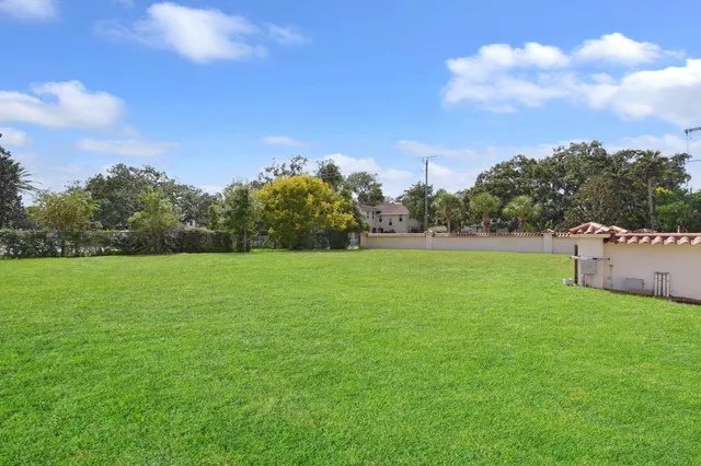 a view of a park with large trees and a big yard