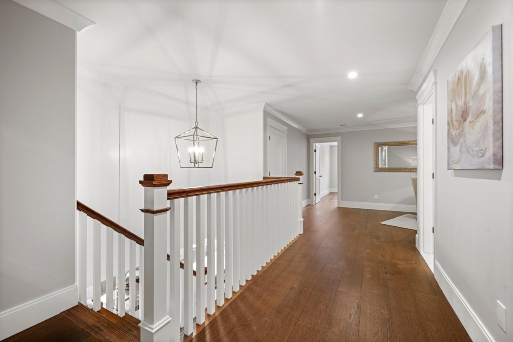 5 Wayside Road Natick, MA 01760 - Photo 18 of 29 a view of a hallway with wooden floor and stairs
