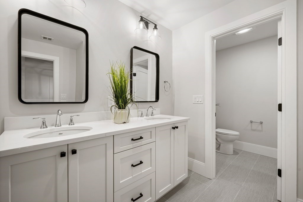 5 Wayside Road Natick, MA 01760 - Photo 22 of 29 a bathroom with a toilet a sink a and mirror