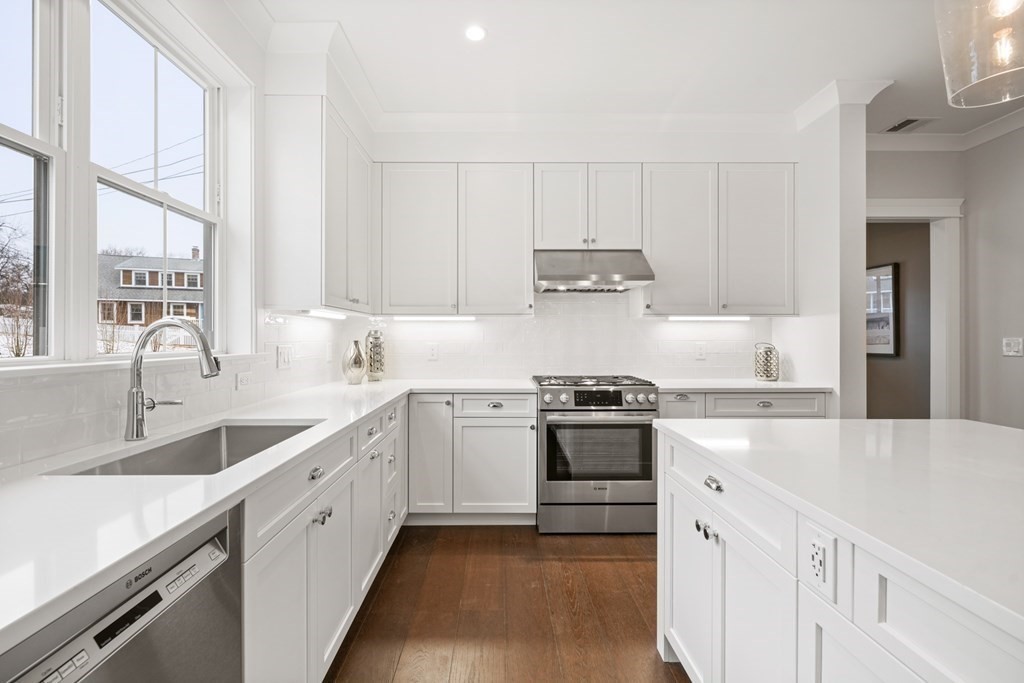 5 Wayside Road Natick, MA 01760 - Photo 3 of 29 a kitchen with granite countertop white cabinets and white appliances