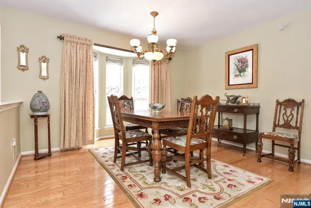 a spacious bedroom with a bed dresser and a window