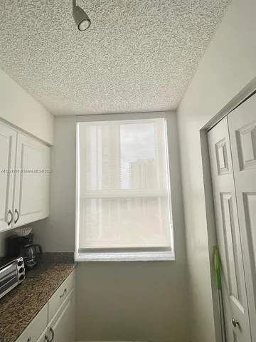 a bathroom with a granite countertop sink a mirror and a shower