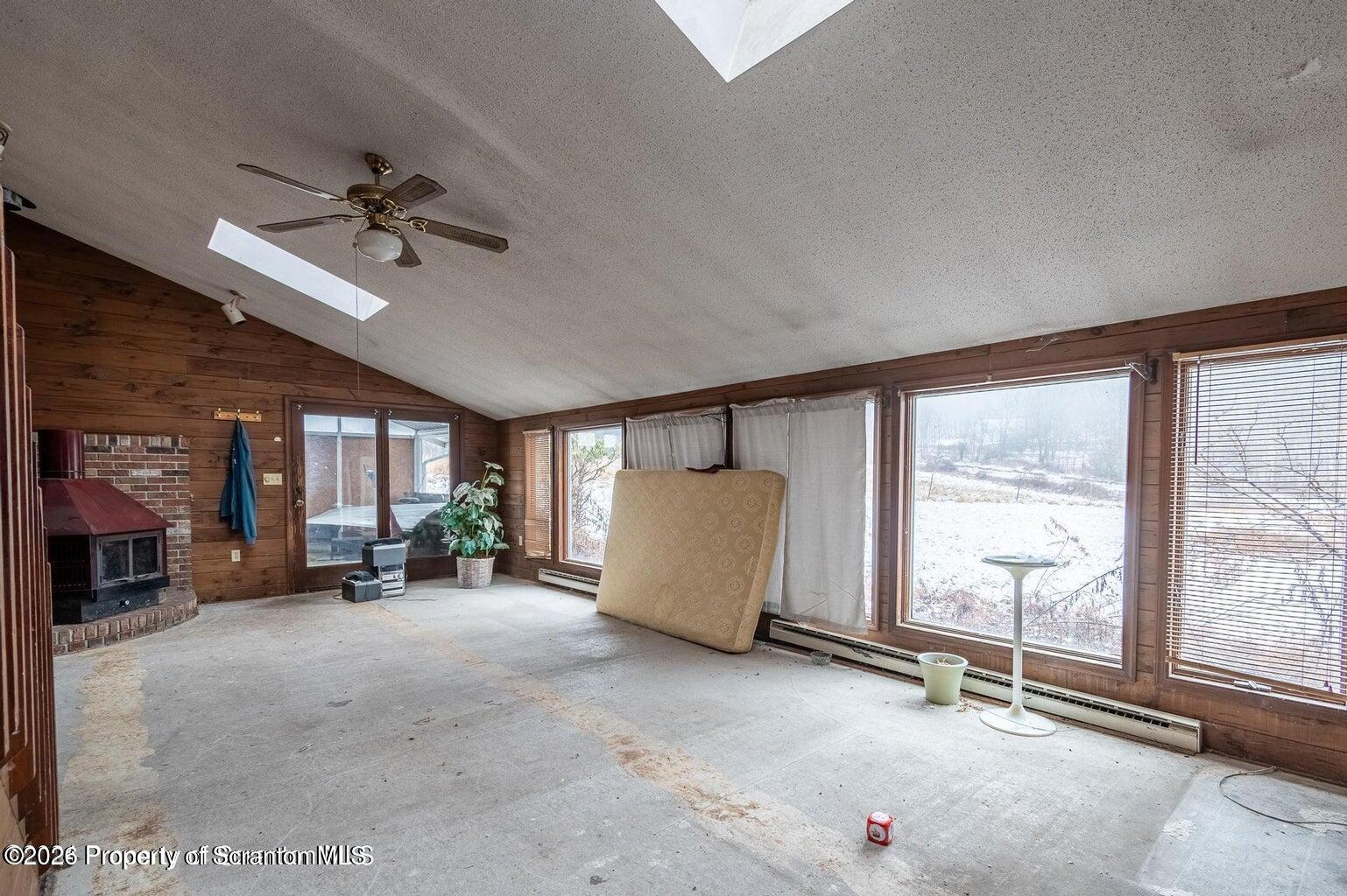 1777 Lamb Road Thompson, PA 18465 - Photo 8 of 31 a view of a livingroom with furniture and a window